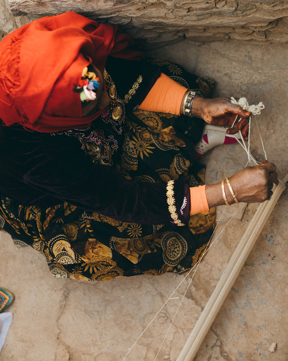 A woman weaver from the Anti Atlas set the weft of a new loom.
