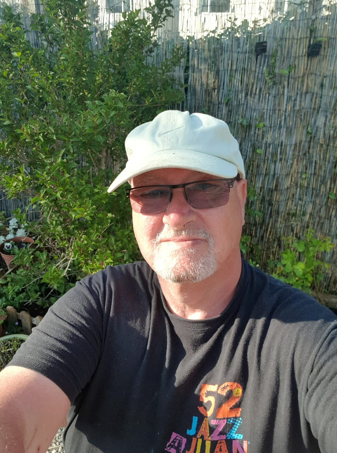 John in a hat and T shirt in the sun