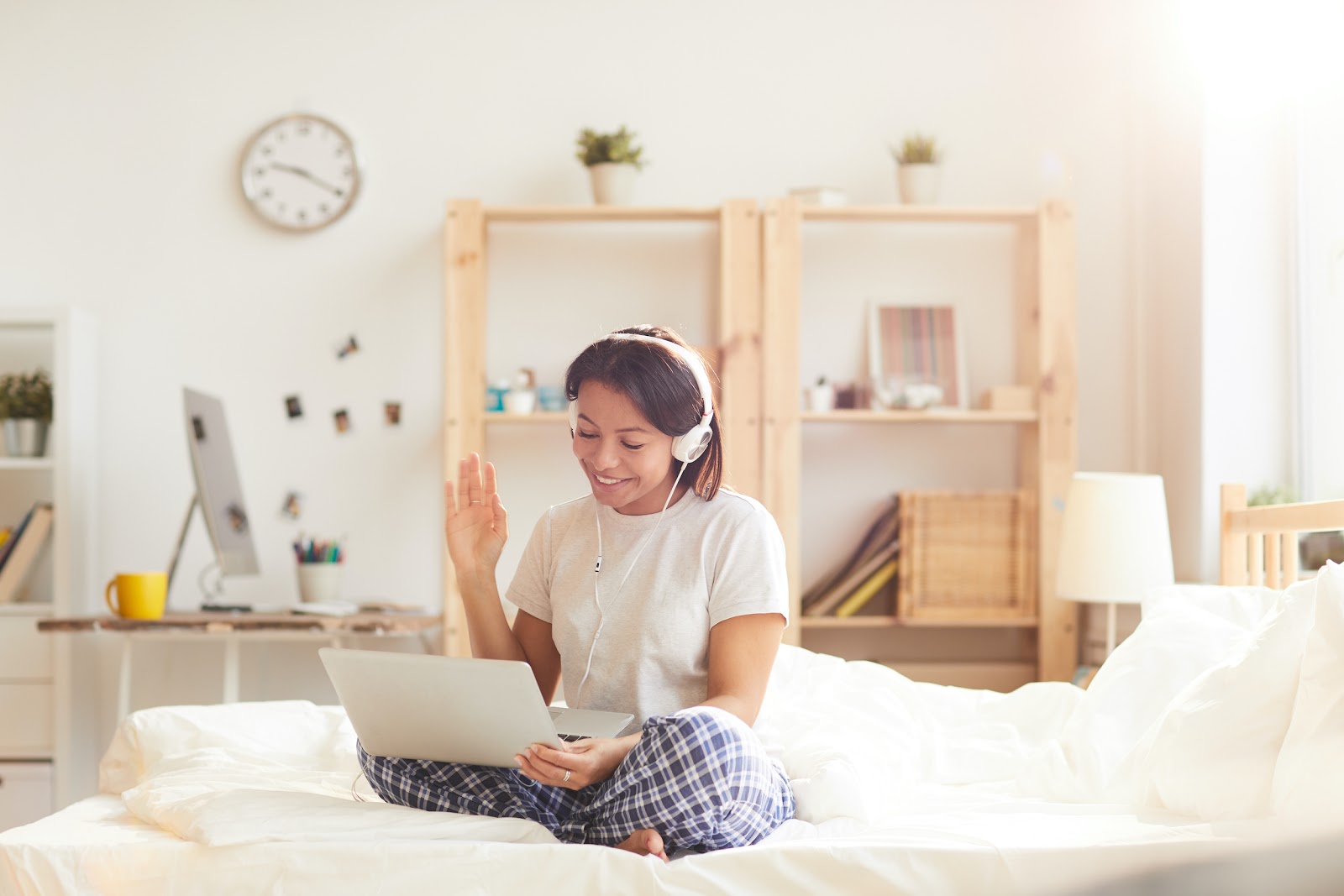 woman on laptop waving