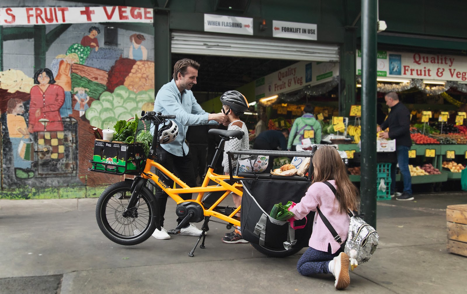 Dad and kids loading Tern GSD with things from the green grocer