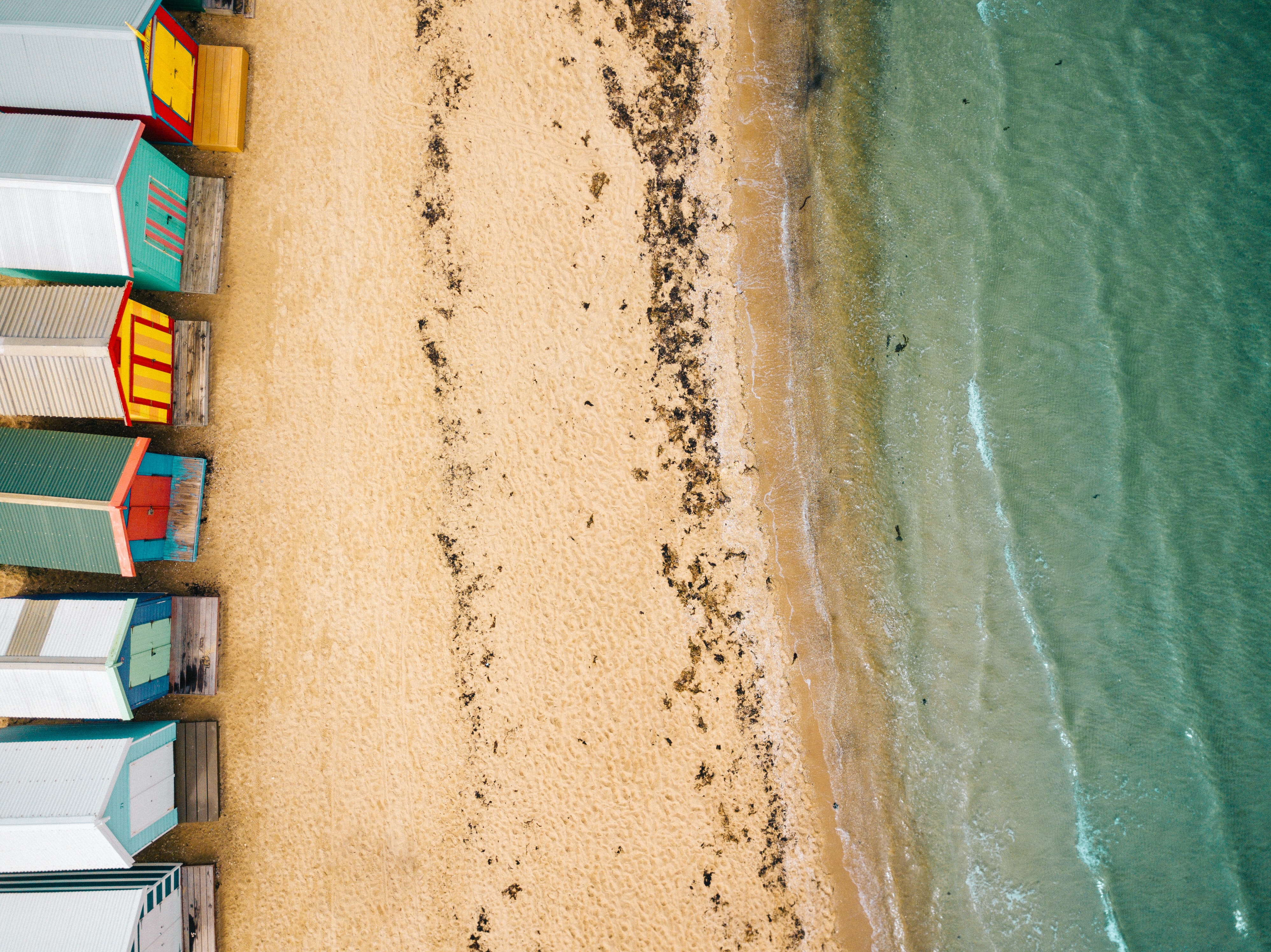 Looking down on Brighton Beach and colourful bathing boxes from above