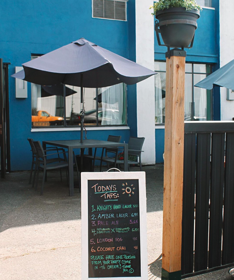 Dogwood Brewing patio on a sunny day with A-Frame sign