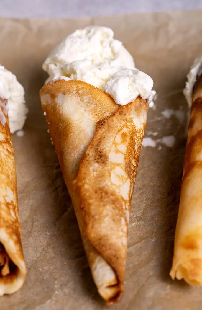 homemade waffle cones with vanilla ice cream in them