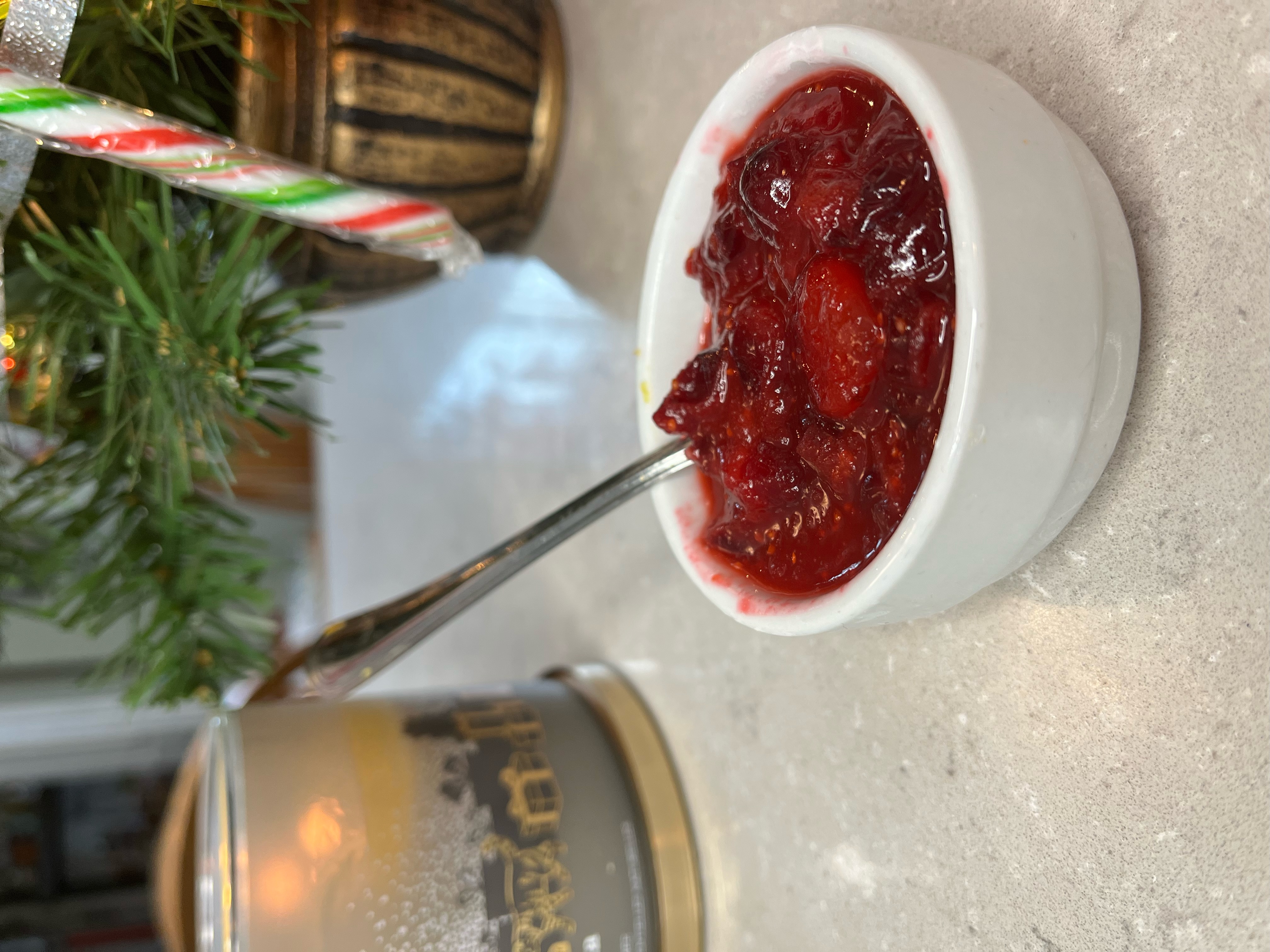 cranberry sauce in a bowl in front of blurred Christmas background 