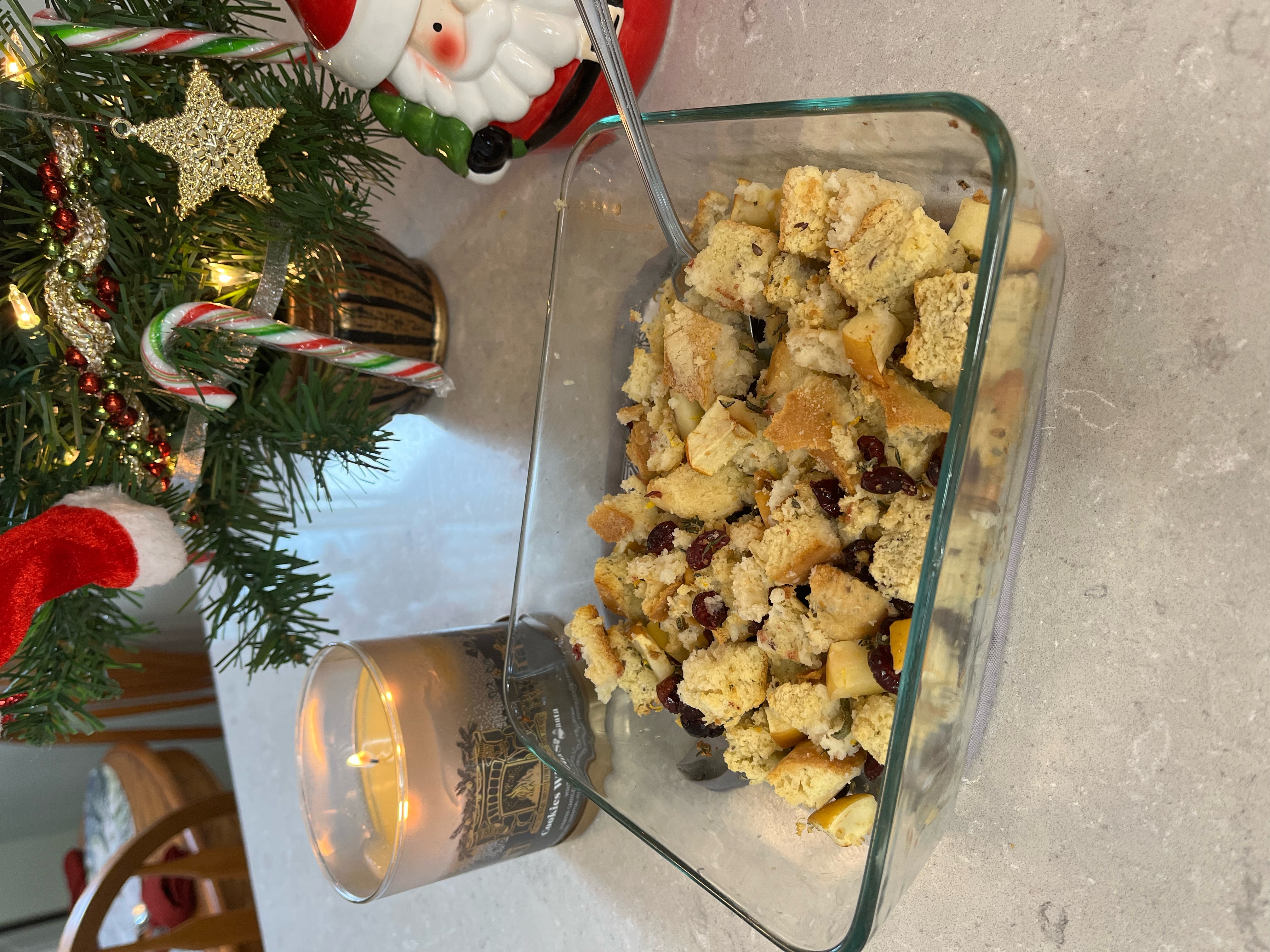 stuffing in a pan in front of blurred Christmas background 