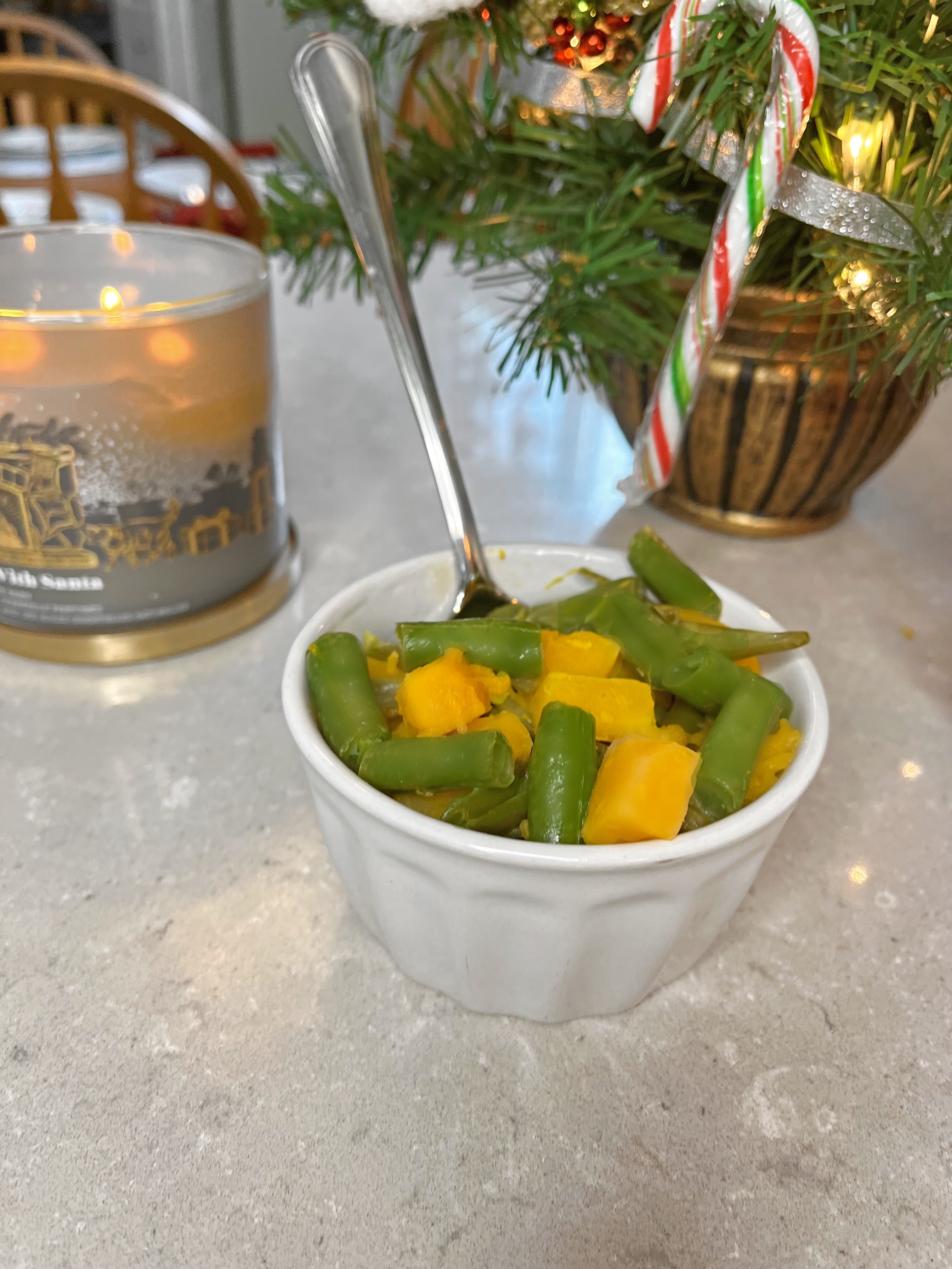 Green beans and squash in front of blurred Christmas background 