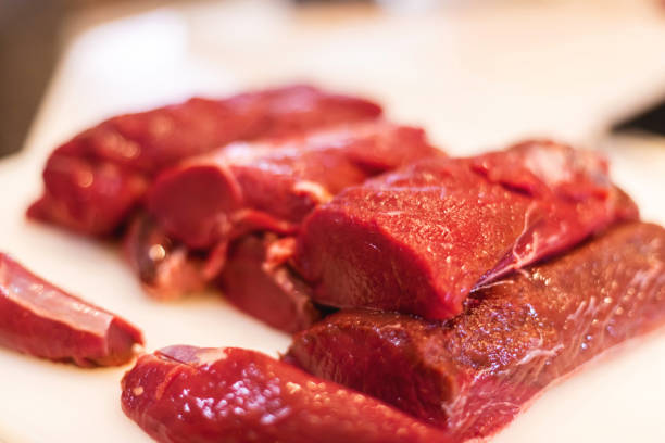 Venison Tenderloin Processing Wild Game Mule Deer Meat in Western Colorado Following Hunting Harvest Photo Series Cutting Venison Tenderloin and Steaks Grinding Meat into Burger Hunting in Western Colorado Following Hunting Harvest Processing Wild Game Mule Deer Meat Photo Series with Matching 4K Video Available (Shot with Canon 5DS 50.6mp photos professionally retouched - Lightroom / Photoshop - original size 5792 x 8688 downsampled as needed for clarity and select focus used for dramatic effect) venison stock pictures, royalty-free photos & images