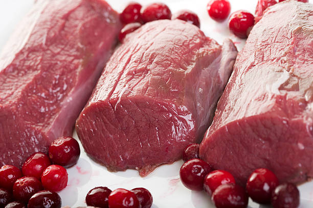 venison raw venison prepared with berries venison stock pictures, royalty-free photos & images