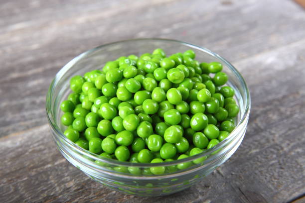 Fresh green peas in a bowl Fresh green peas in a bowl green peas stock pictures, royalty-free photos & images
