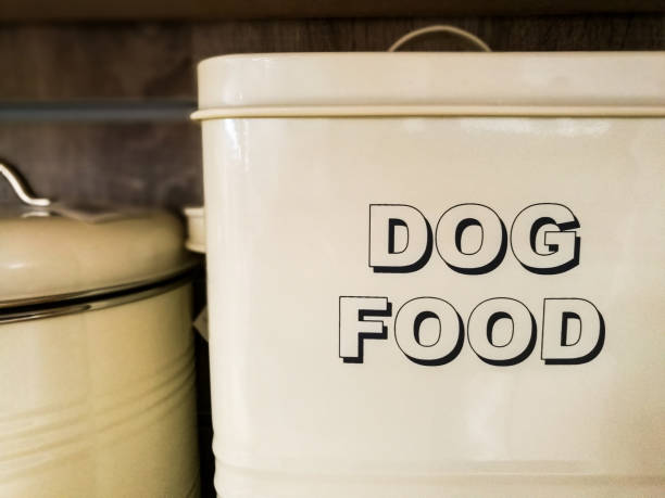 Large white metal tin with the words 'Dog Food' written in bold capital letters Close up color image depicting a large white metal tin or container with the words 'Dog Food' written in bold black capital letters. Room for copy space. dog food container stock pictures, royalty-free photos & images