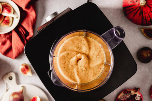 Freshly made smoothie in the blender jar Freshly made smoothie mixture in the blender jar in the kitchen. Preparing healthy smoothie in kitchen. pumpkin smoothie stock pictures, royalty-free photos & images