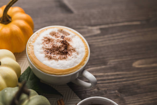 Pumpkins spice latte Pumpkins spice latte on a wooden and orange background with copy space pumpkin spice latte dog stock pictures, royalty-free photos & images