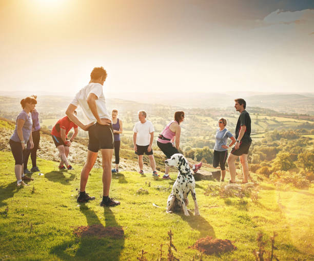 Shot of a group of people going for a run in nature Surround yourself with people who support self improvement dog group training stock pictures, royalty-free photos & images