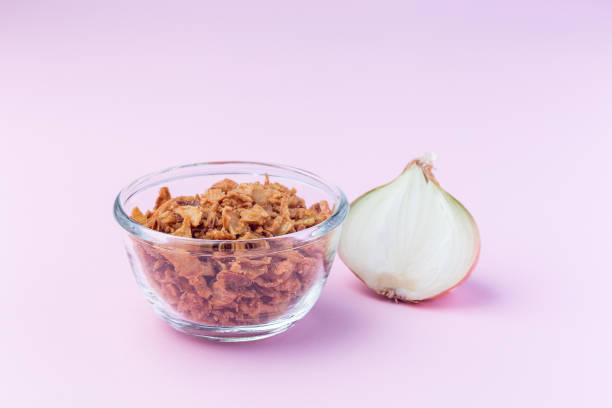 Fried onion in the glass, topping for hot dog, fast food, horizontal on pink background Fried onion in the glass, topping for hot dog, fast food, horizontal on a pink background dog onion stock pictures, royalty-free photos & images