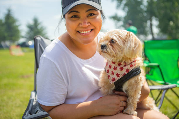 Summer bonding Young woman hugging small dog dog canada stock pictures, royalty-free photos & images