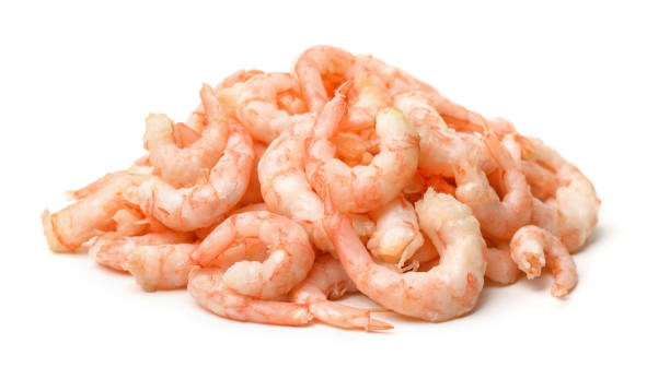 Pile of boiled peeled  shrimps Pile of boiled peeled  shrimps isolated on white cooked shrimp stock pictures, royalty-free photos & images