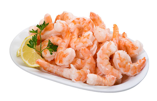 Shrimps(+clipping path) A plate full of prepared prawns,isolated on white background with clipping path. cooked shrimp stock pictures, royalty-free photos & images