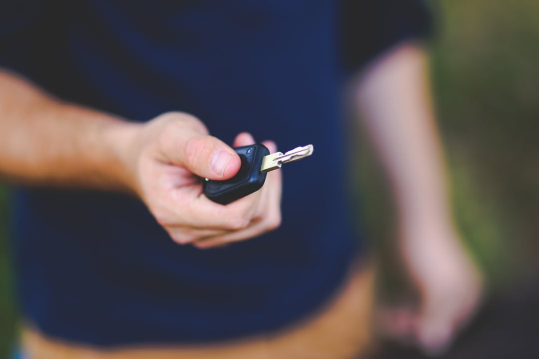 Man handing key to car over