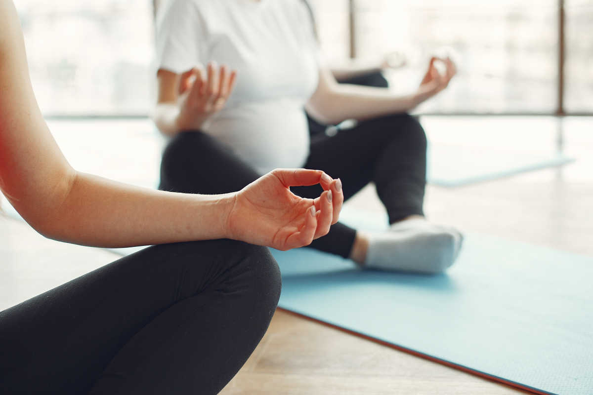 Thinking about meditation and seizures as women meditate in a class