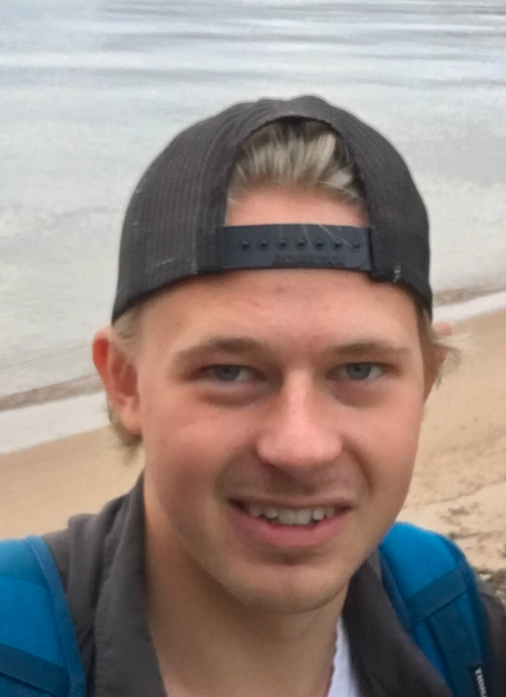 A selfie of Hunter next to the water.