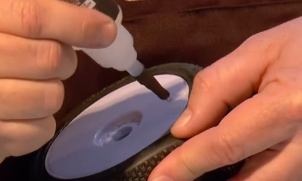 Image of someone gluing an RC car tire