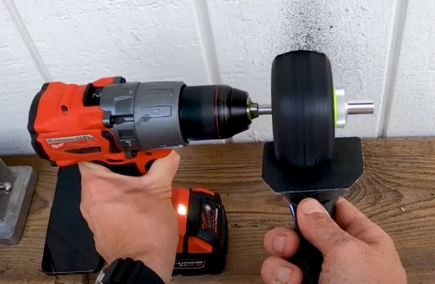 Photo of Ryan Harris sanding treads off a tire