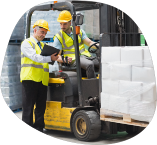 A supervisor explaining safety documentation to a forklift driver
