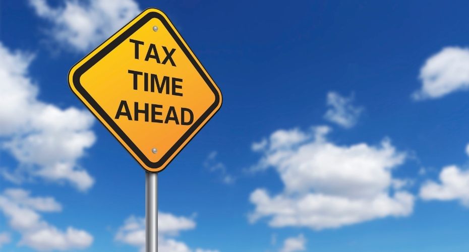 A traffic caution sign reads: Tax Time Ahead.