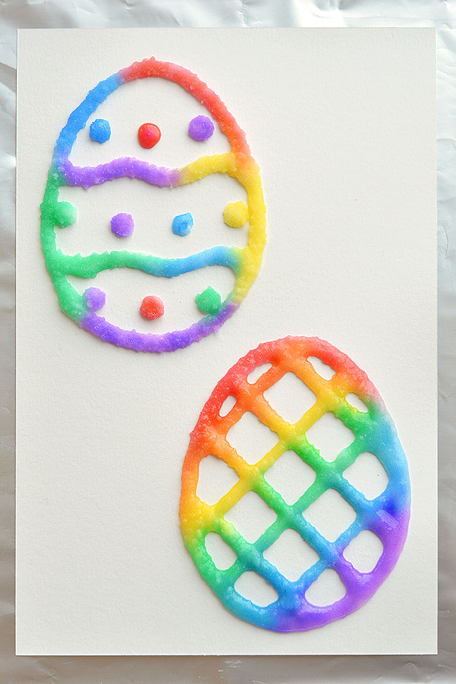 These salt painted Easter eggs are such a fun and easy craft idea for spring time! With a little bit of salt and glue you end up with colorful puffy paint like shapes with an awesome texture! They even stay puffy after they dry. Cut out the eggs to make an Easter basket craft, or you can make cute DIY Easter cards! This is such a great Easter craft for kids!