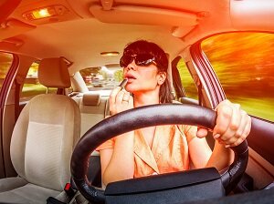 Woman Putting on Makeup While Driving