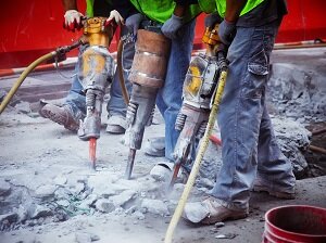 Three Workers Using Jack Hammers