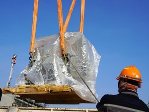 Worker Watching Crane Lift Heavy Load