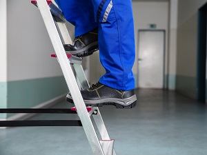 Workers Legs, Feet Standing on Step Ladder
