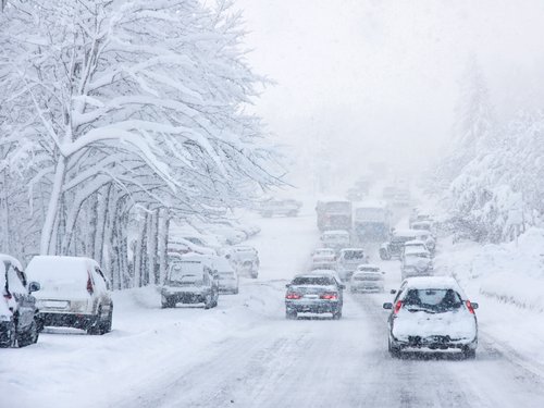 Cars Driving in Snowy Weather