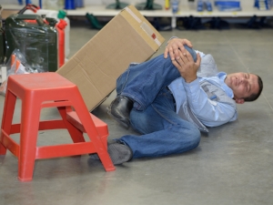 Warehouse Worker Tripped., Grasping at Hurt Knee