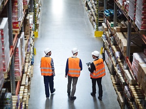 Three Warehouse Workers Wearing Hard Hats
