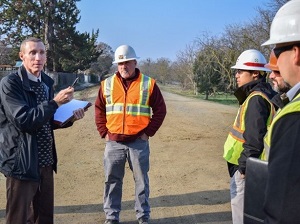 OSHA Compliance Officer Talking to Crew Members at Job Site