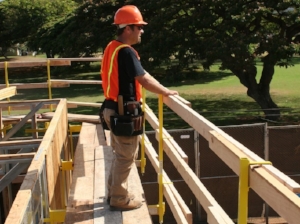 Construction Worker Standing Near Constructed Guardrail