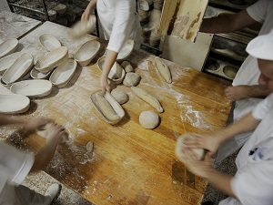 Bakers Preparing Bread to Bake in Bakery