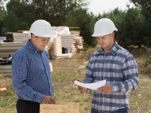 Two Supervisors Wearing Hard Hats on Construction Site