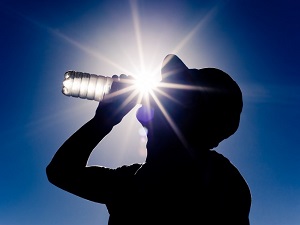 Worker Drinking Bottled Water in Heat