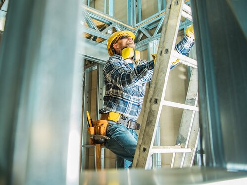 Construction Worker Climbing Extension Ladder