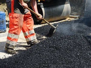 Road Workers Laying Asphalt