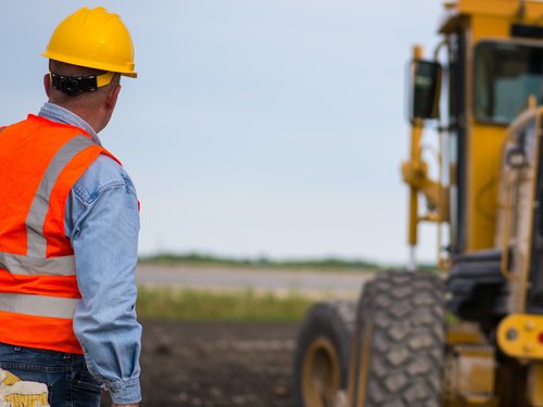 Construction Worker and Grader