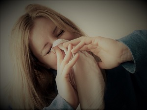 Woman Coughing into Napkin