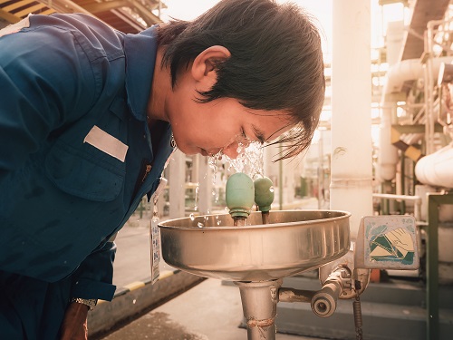 Industrial Worker Using Eye Wash Station
