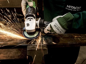 Gloved Hands Using Portable Grinder on Metal, Sparks Flying