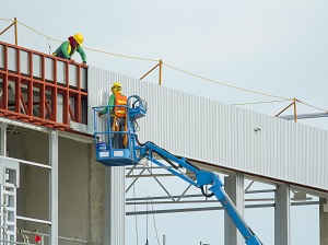 Worker in Aerial Lift at Construction Site