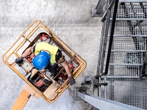 Aerial View of Construction Worker in Man Lift