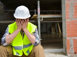 Construction Worker Sitting Down at Construction Site, Feeling Tired